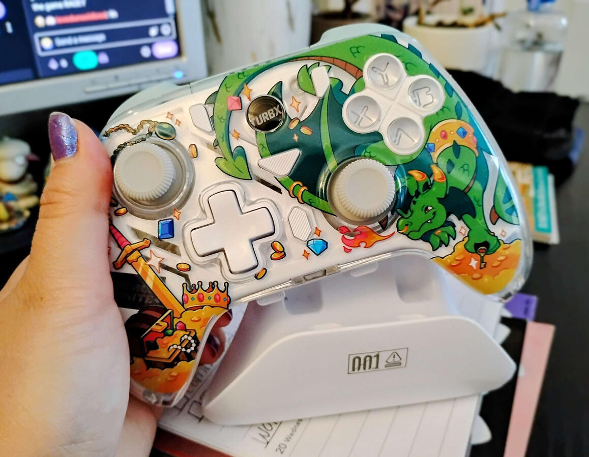 TurbX Controller Gaming controller held over charging dock.